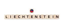 Wooden blocks bearing the name and flag of Liechtenstein. Liechtensteiner and European Culture, national identity, travel, and geography in a copy space design.