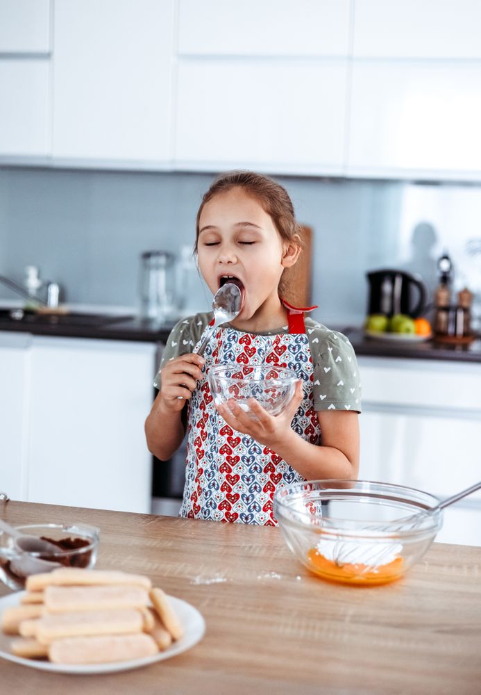 Girl making tiramisu in the kitchen