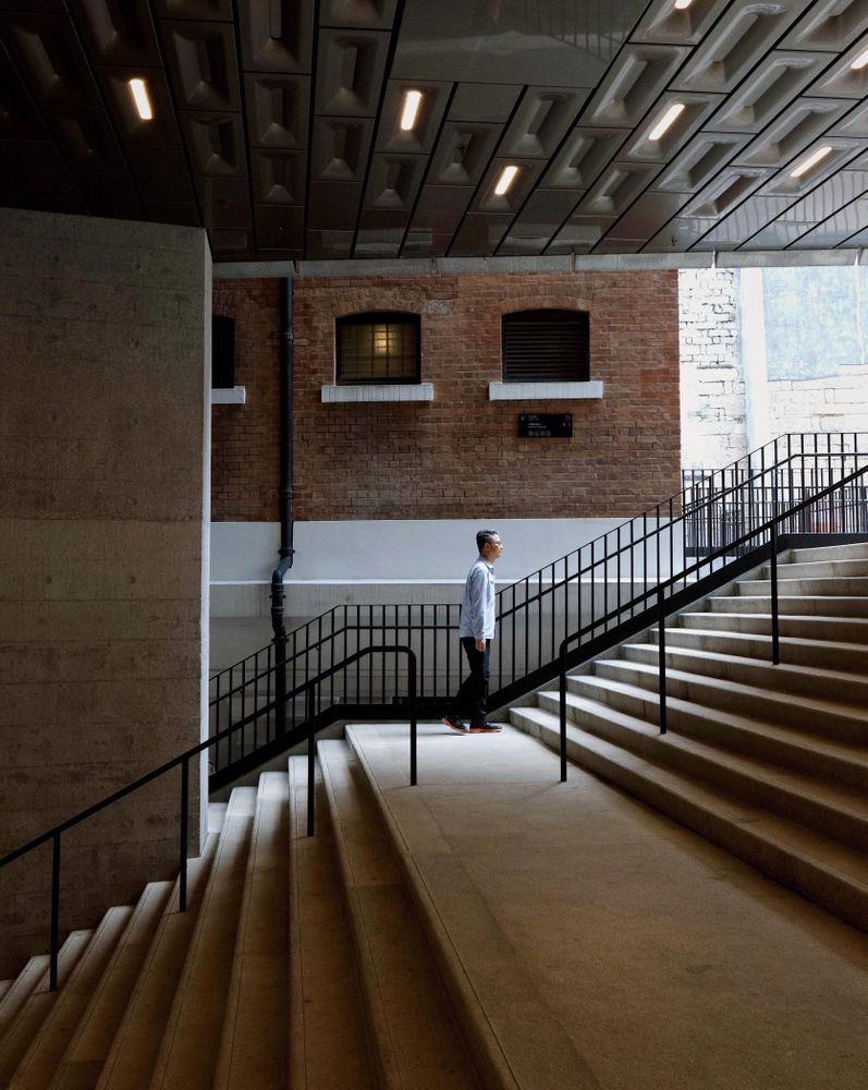 Side view of man in light shirt climbing staircase