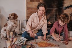 Happy woman and boy painting together