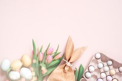 Flat lay of Easter eggs, tulips and paper bag with copy space