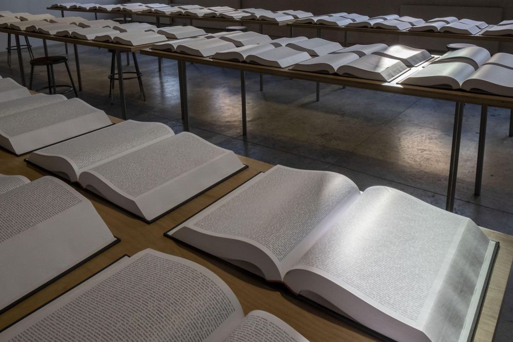 Open books on wooden tables in a room