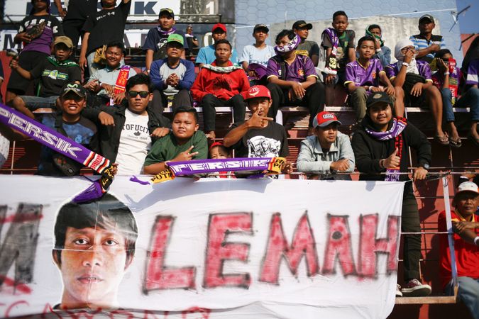 Kedira, East Java Indonesia - October 4, 2019: Fans with signs and banners at soccer game