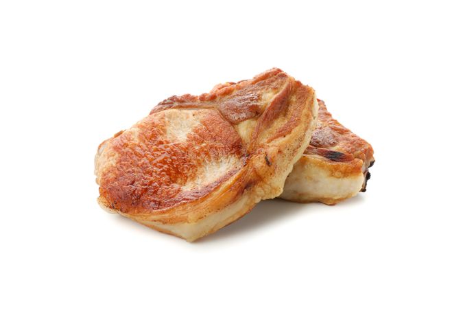 Fried pork steaks isolated on light background. Grilled food