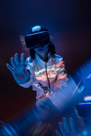 Woman touching air in VR glasses