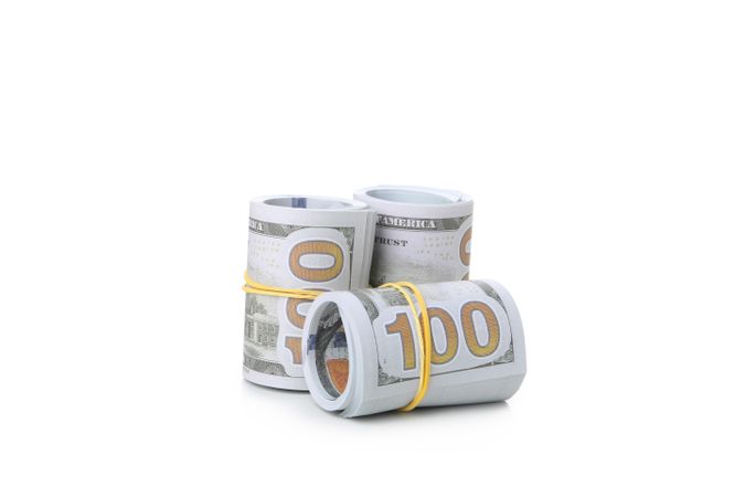 Rolls of Dollar bills isolated on light background