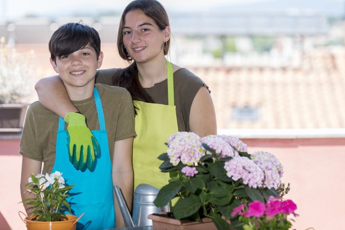 Two happy teenager on patio posing after gardening