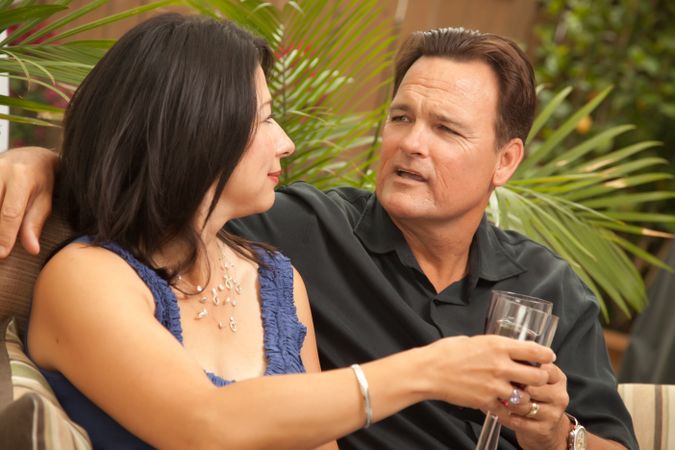 Interracial Couple Talking and Drinking Wine