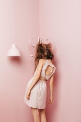 Back view of a young woman with hair tangles in coat hanger