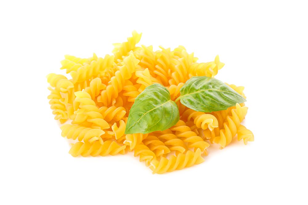 Pasta isolated on bright background. Uncooked whole wheat pasta