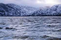 Shore with mountains near water