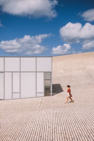 Woman next to contemporary building