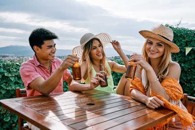 a group of young people having a good time in a summer day and cheering with beer