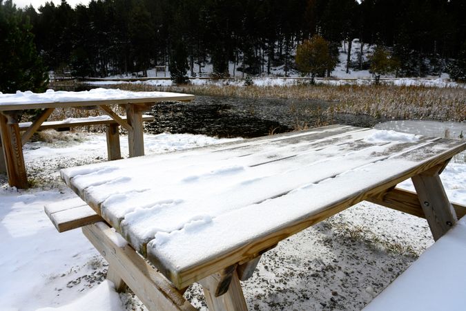 Snowy picnic bench in park