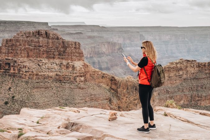 Active female photographing pictorial landscape
