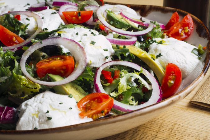 Vegetables salad with onion greens and cream sauce