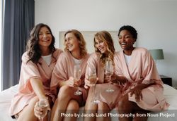 Females in sleeping robe sitting on bed and having champagne 5pzBxb