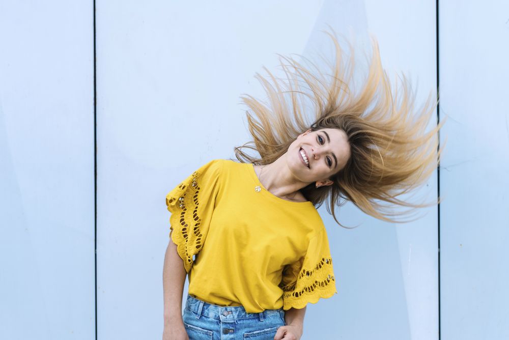Young woman shaking hair