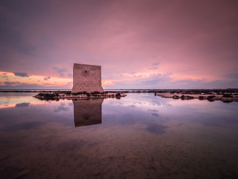 Wonderful watchtower in calm lake on cloudy day