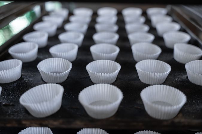 Empty cupcake mold ready to be filled on a baking tray