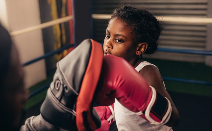 Close up of a girl training inside a boxing ring