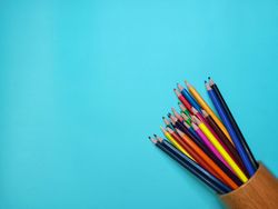 text space or arrangement of words on a light blue background and color pencils