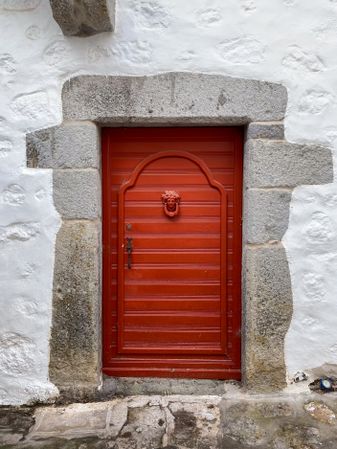 Patmian red door with figurehead knocker