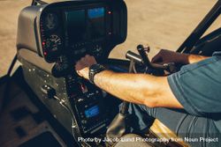 Pilot's hand on an helicopter instrument panel 5Rk3W4