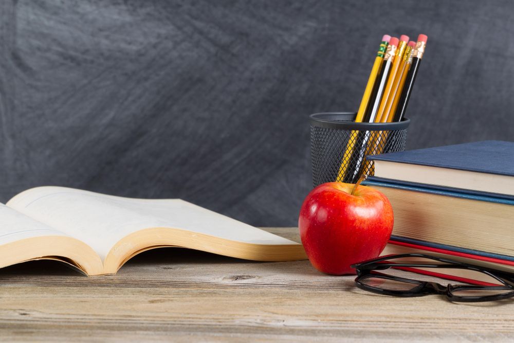 Desk with reading materials and chalkboard