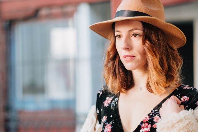 Smiling woman in dress and hat