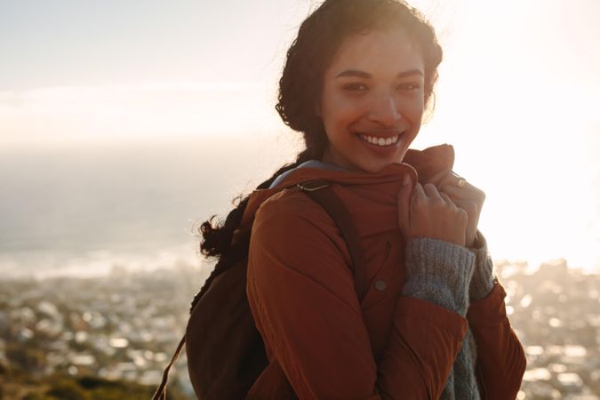 Portrait of woman smiling with bright sunshine on a winter day