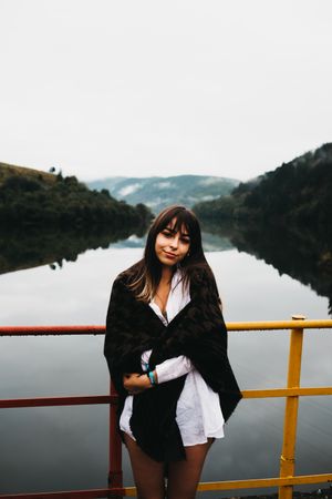 Woman standing looking amazing lake near mountains