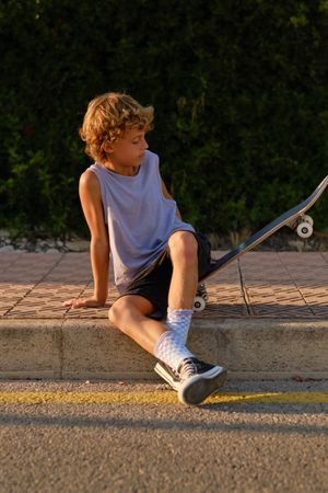 Boy with skateboard in city