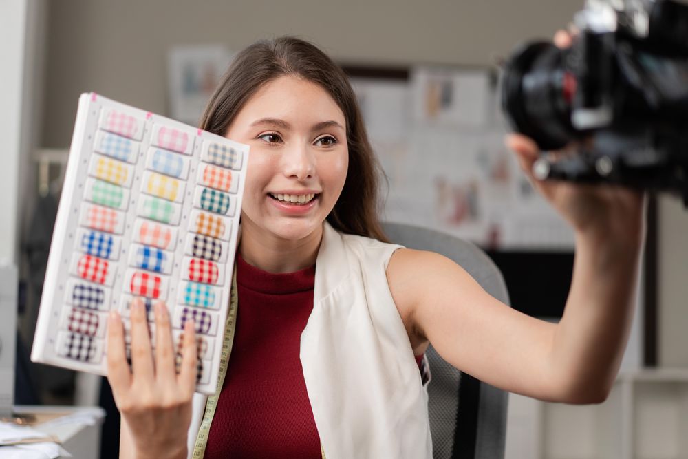 Fashion designer woman filming live video for selling clothes