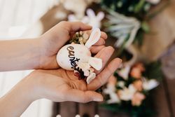 Woman holding Easter egg with rabbit ears