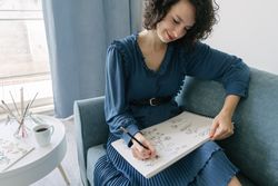 Woman artist drawing at sofa