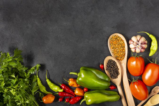 Ingredients for cooking with tomatoes, various peppers, garlic and green peppers.