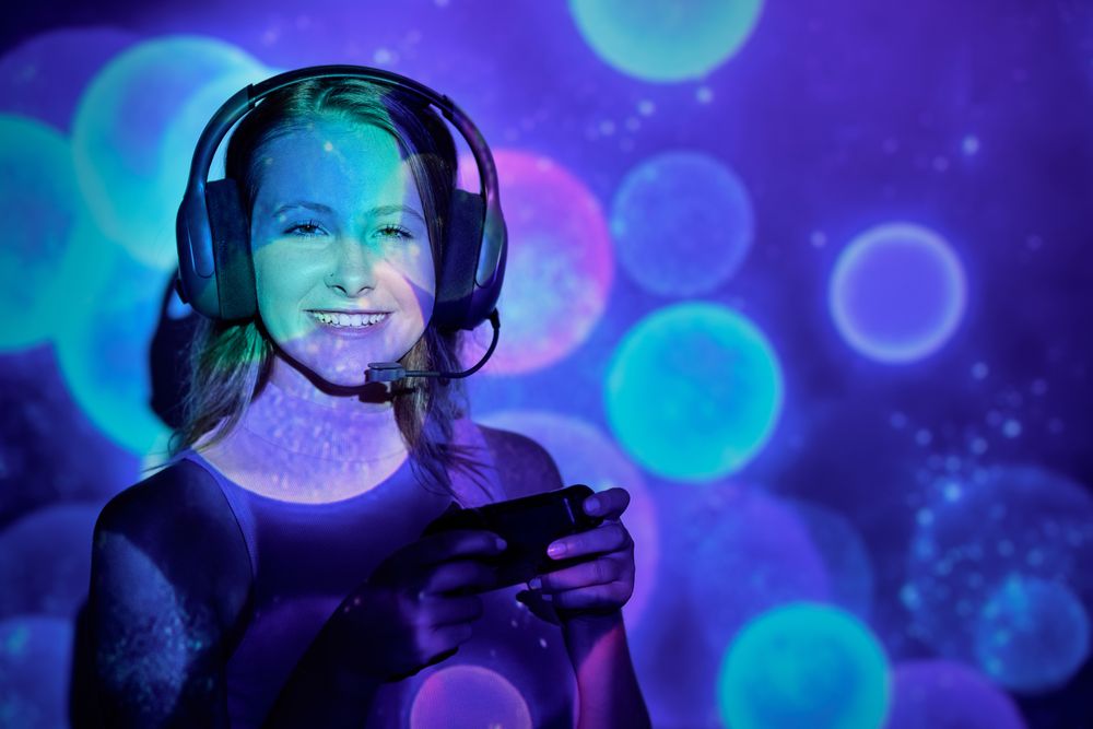 Optimistic woman playing videogame under sparkles
