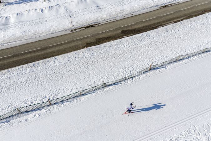 Skier running on the track. Snow field. Aerial.