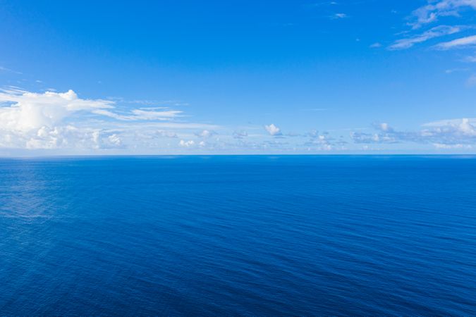 Clear blue Indian Ocean under a blue sky with clouds, landscape
