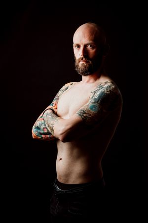Young shirtless bearded guy with tattoos