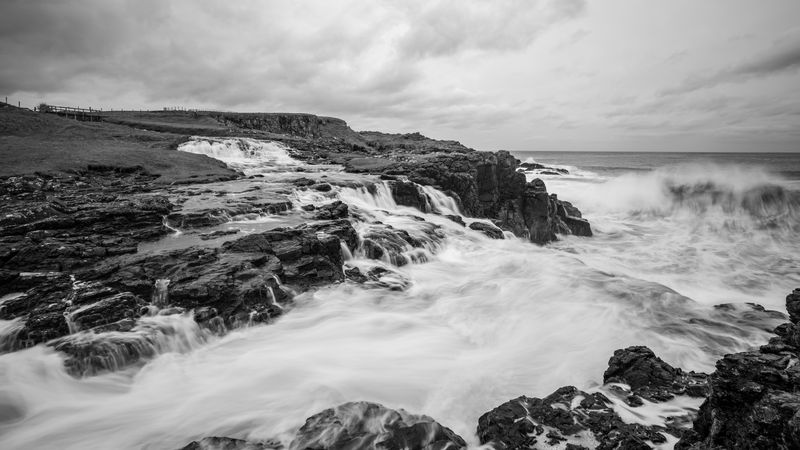 Waves breaking on shore on stormy day