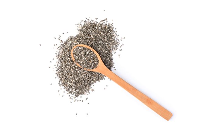 Chia seeds and wooden spoon isolated on plain background