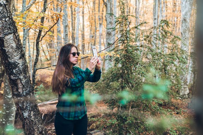 Casual tourist making photo on smartphone of nature