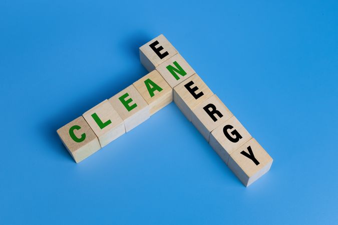clean energy words text on wooden blocks isolated on blue background