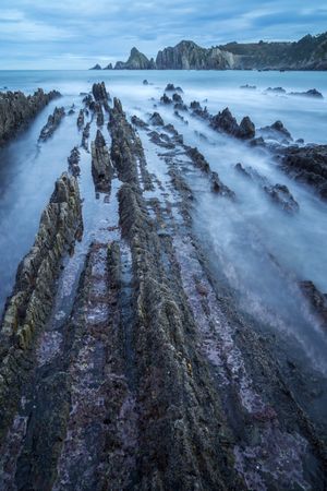Foggy landscape of Playa de Gueirua rock seashore