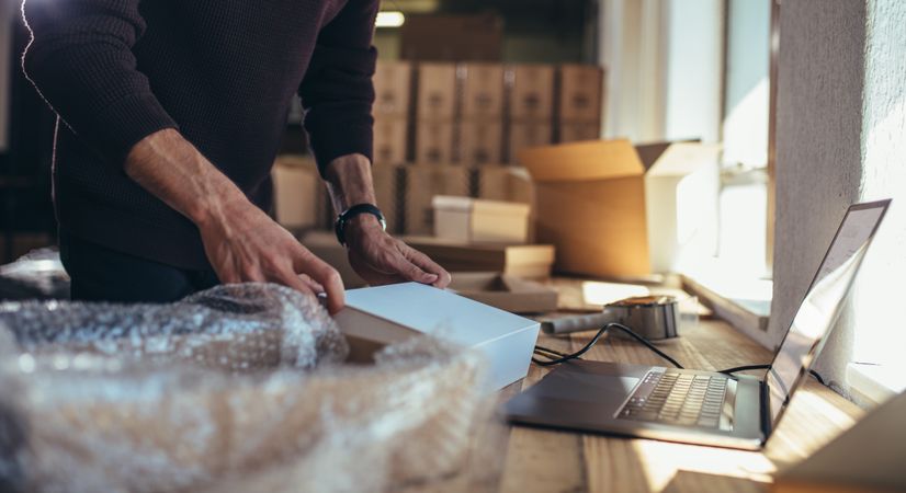 Small business owner packing in the card box at workplace