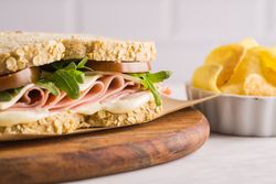 Delicious sandwich with ham, cheese, lettuce and tomato