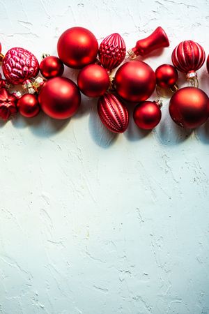 Christmas red baubles in line at top of picture