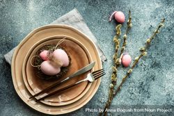 Top view of Easter holiday table setting with decorative pink Easter eggs & pussy willow 4Bavnk